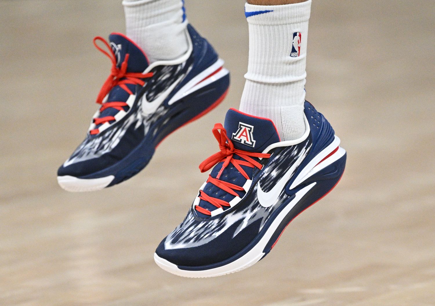 View of navy, white, and red Nike shoes.